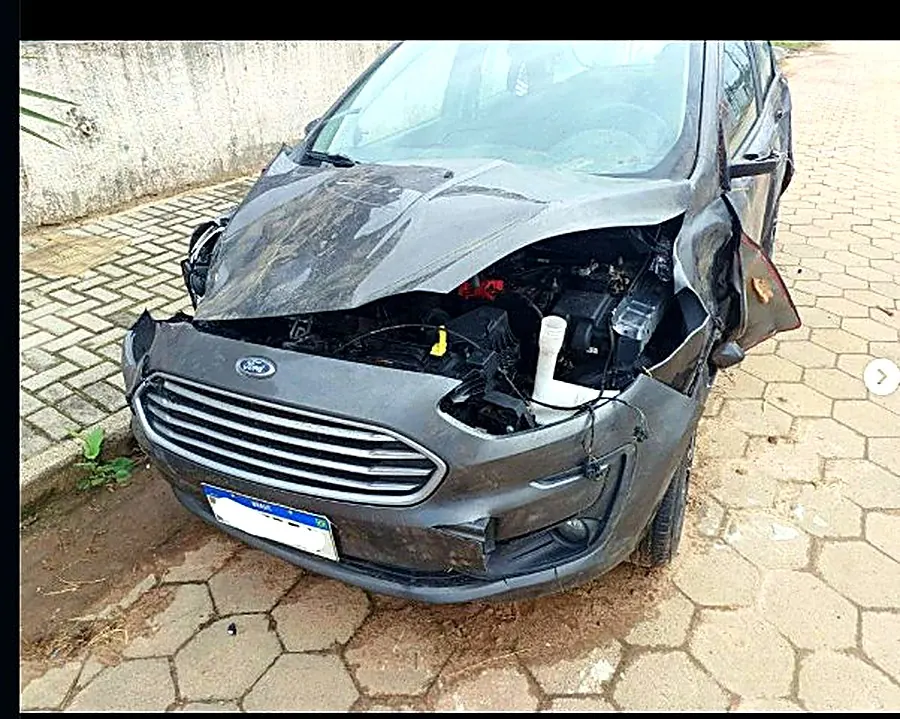 Ford cinza com o capô amassado e a dianteira danificada antes do reparo